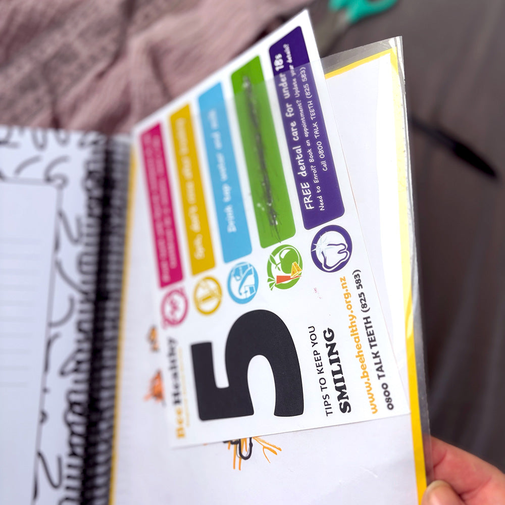 My School Days school record book open to show clear pocket with certificate and child's artwork tucked in, spiral binding and lined inner pages visible, by Paper Heart Design NZ