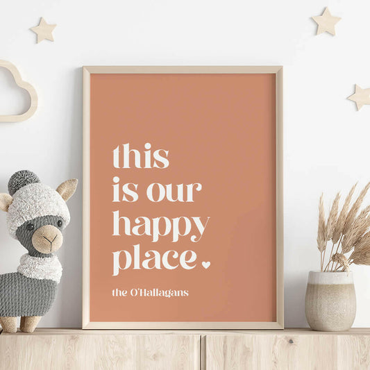 This Is Our Happy Place personalised family print in clay framed on shelf with llama stuffed toy, wooden stars on wall and vase with dried plant, by Paper Heart Design NZ