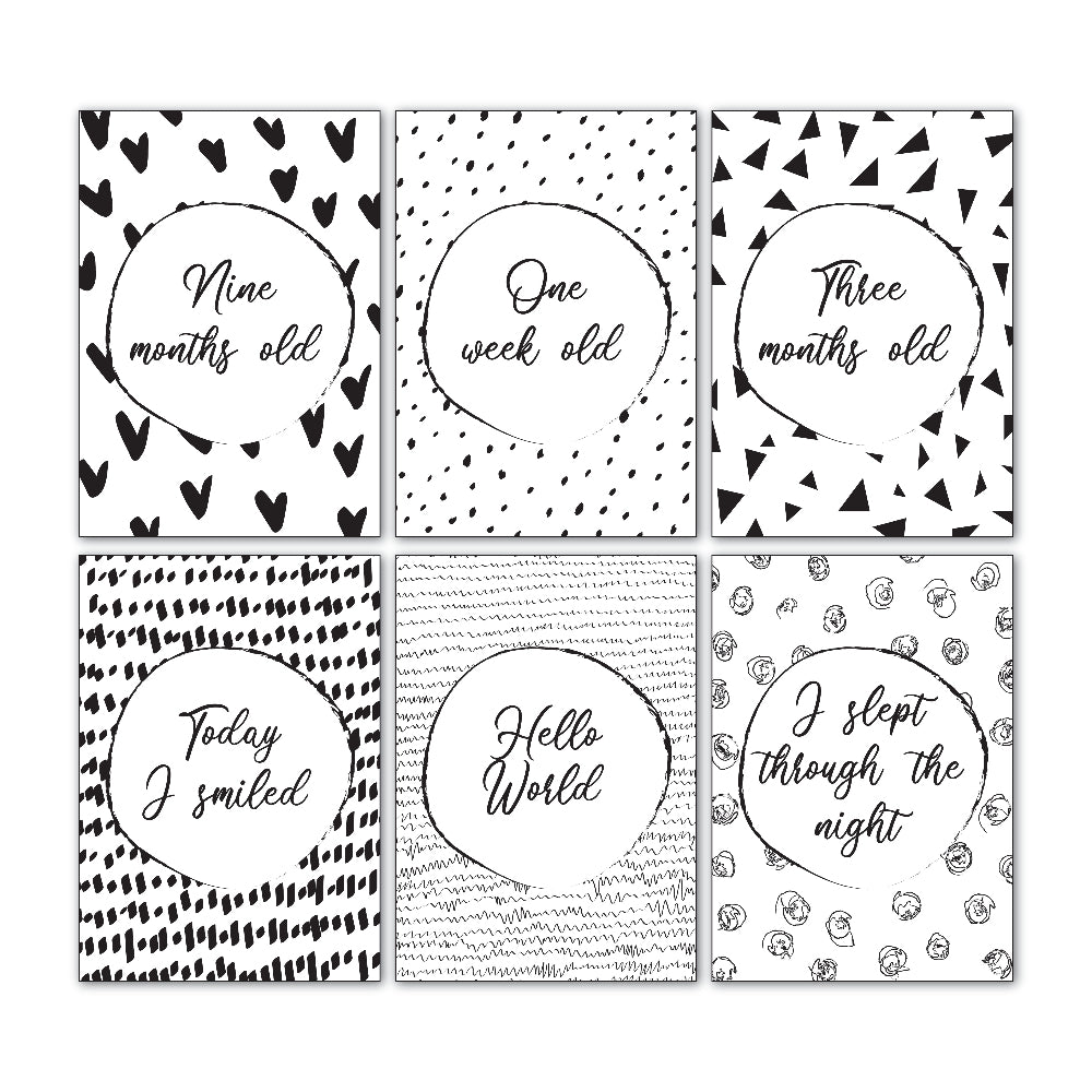 Downloadable baby milestone cards showing six sample designs from the 30 card set, black and white script font, printable keepsake cards by Paper Heart Design