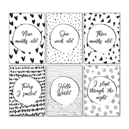 Downloadable baby milestone cards showing six sample designs from the 30 card set, black and white script font, printable keepsake cards by Paper Heart Design