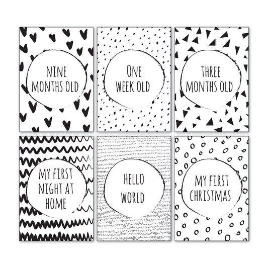 Downloadable baby milestone cards showing six sample cards from the 30 card set, monochromatic design with handwriting font, printable keepsake cards by Paper Heart Design