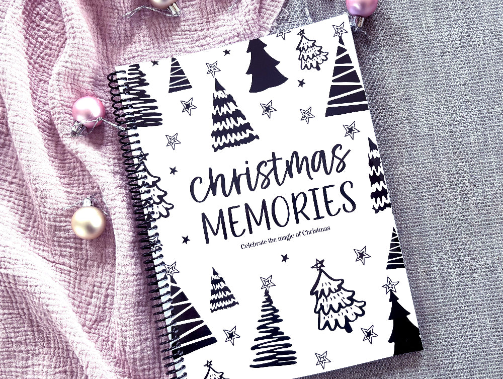 Christmas Memories keepsake book flat lay on pink background with Christmas decorations, by Paper Heart Design