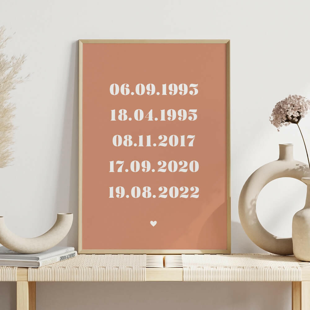 Family Dates personalised print framed in clay with white bold serif font on shelf with white vases, family wall art by Paper Heart Design