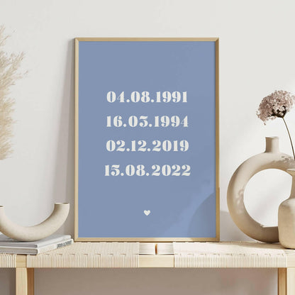 Family Dates personalised print framed in cornflower with white bold serif font on shelf with white vases, family wall art by Paper Heart Design