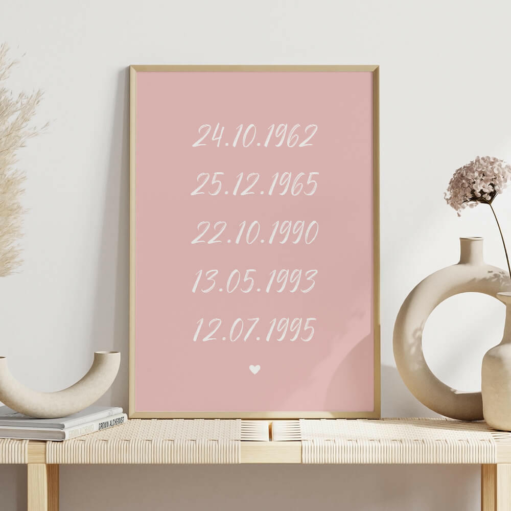 Family Dates personalised print framed in pink with white brush script font on shelf with white vases, family wall art by Paper Heart Design