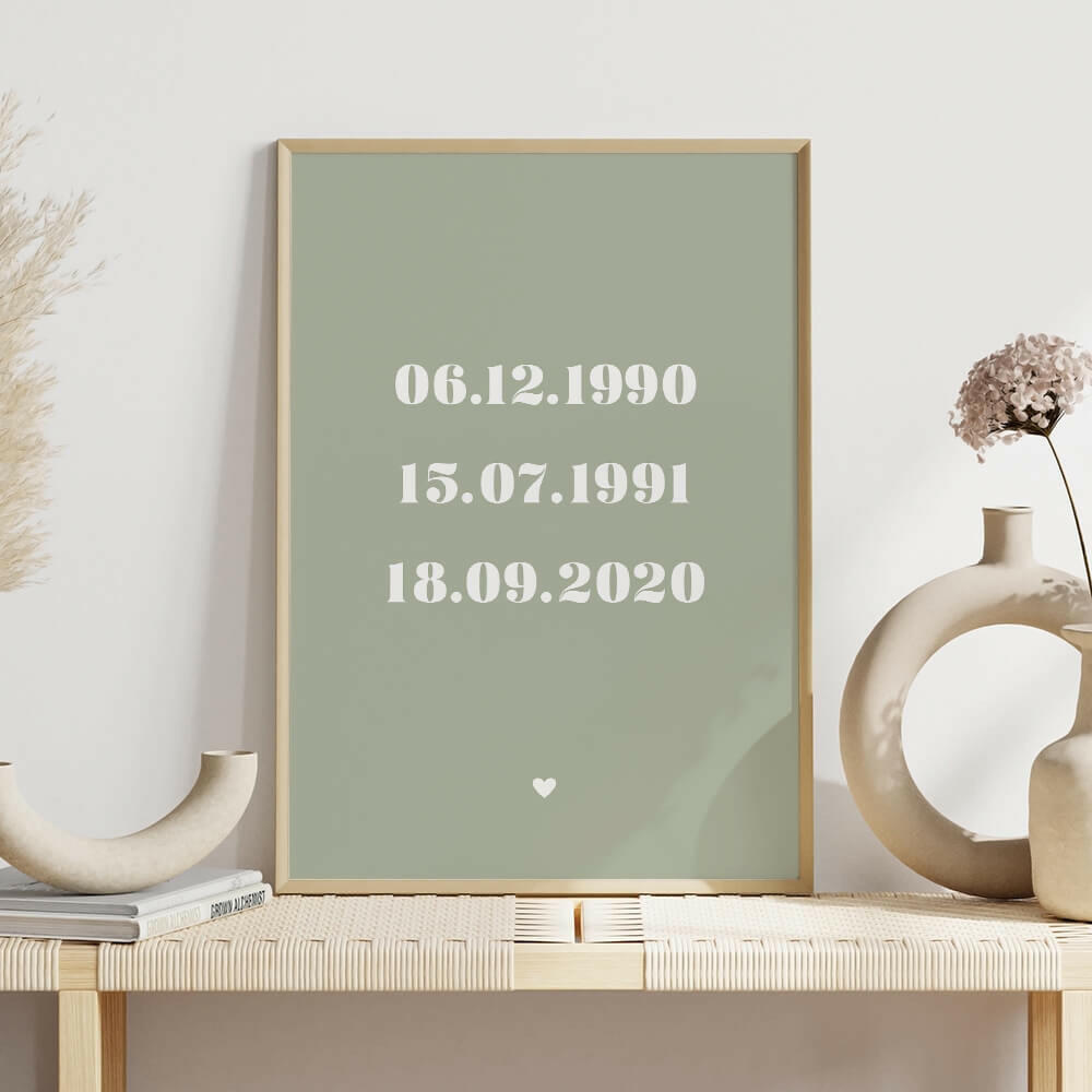Family Dates personalised print framed in sage with white bold serif font on shelf with white vases, family wall art by Paper Heart Design