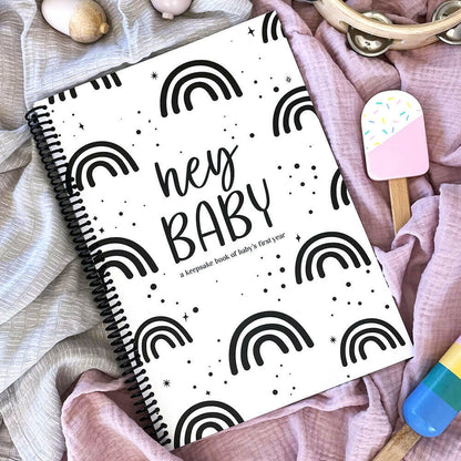Hey Baby first year baby milestone book styled flat lay - NZ designed baby keepsake by Paper Heart Design