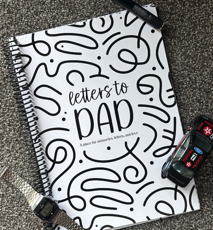 Letters to Dad keepsake book flat lay on grey carpet with watch, toy car and carpenters pencil, Father's Day gift idea by Paper Heart Design NZ