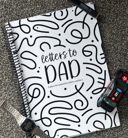 Letters to Dad keepsake book flat lay on grey carpet with watch, toy car and carpenters pencil, Father's Day gift idea by Paper Heart Design NZ