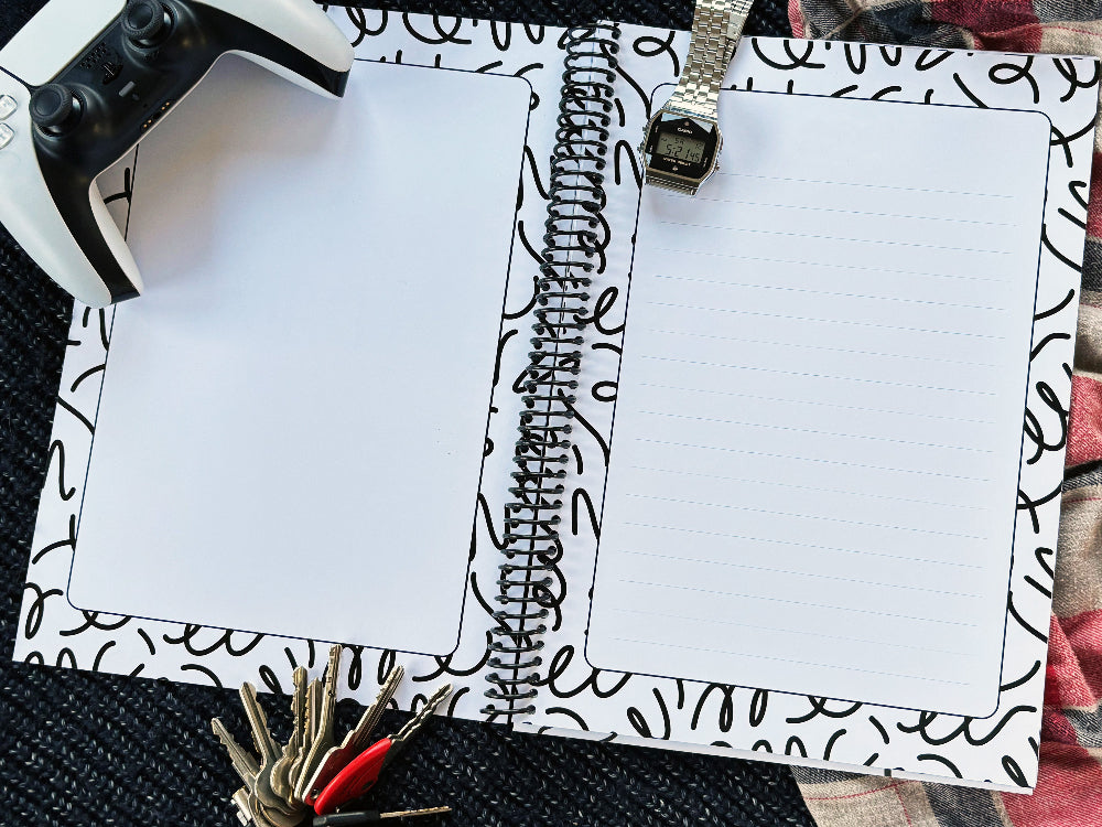 Letters to Dad keepsake book open to lined and blank inner pages on navy knit and red plaid surface with PlayStation controller, Casio watch and keys, by Paper Heart Design NZ