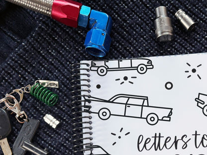 Letters to Dad keepsake book vehicles cover close up showing spiral binding detail with 10mm socket, car keys and AN hose fitting, by Paper Heart Design NZ