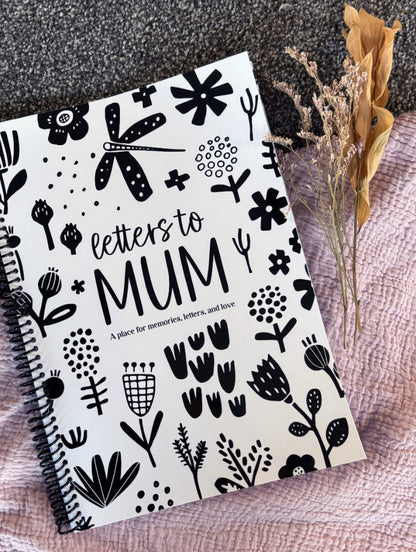 Letters to Mum keepsake book black and white cover flat lay on grey carpet with pink fabric and dried flowers, by Paper Heart Design NZ