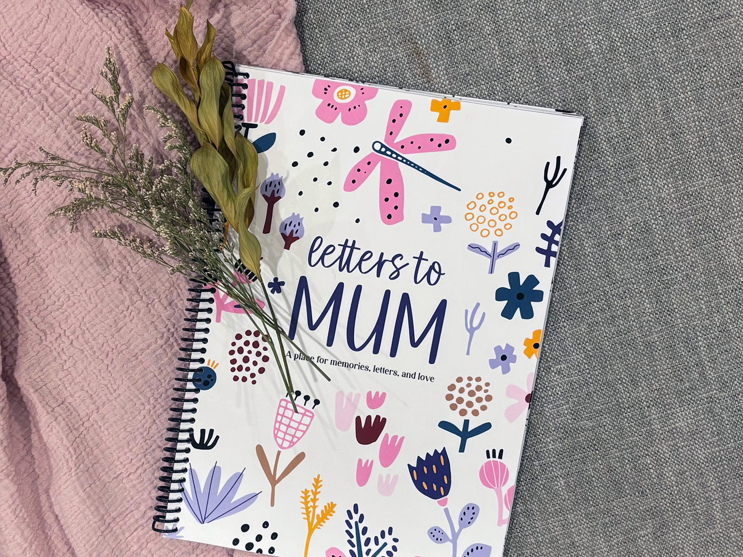 Letters to Mum keepsake book full colour cover flat lay on grey carpet with pink fabric and dried flowers, by Paper Heart Design NZ