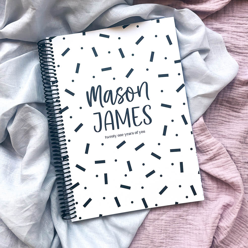 Personalised 21 Years Keepsake Book confetti cover flat lay on pink and grey fabric, custom birthday letter keepsake by Paper Heart Design NZ