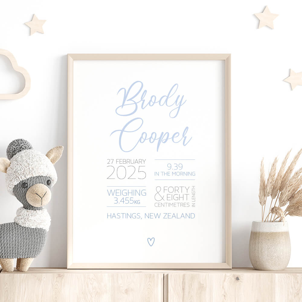 Script Birth Print personalised baby birth print in blue framed on shelf with stars, stuffed toy and dried plant, nursery wall art by Paper Heart Design NZ