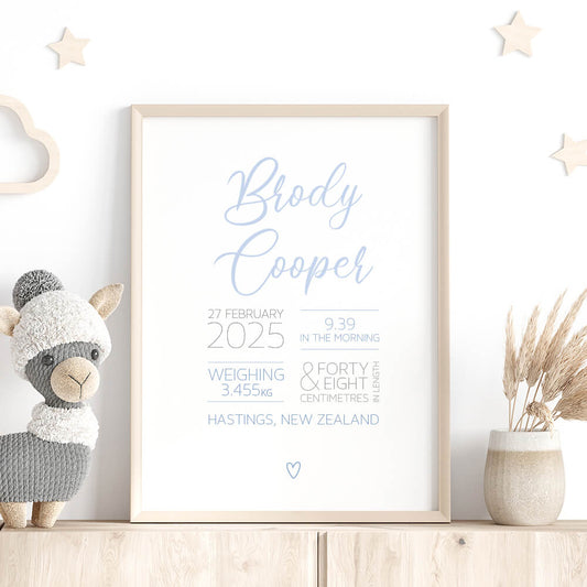 Script Birth Print personalised baby birth print in blue framed on shelf with stars, stuffed toy and dried plant, nursery wall art by Paper Heart Design NZ
