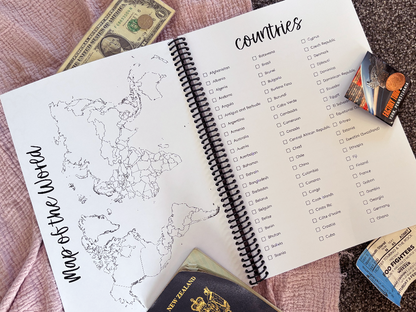Travel Adventures keepsake journal open to world map and countries checklist flat lay on pink and grey surface with passport and tickets, by Paper Heart Design NZ