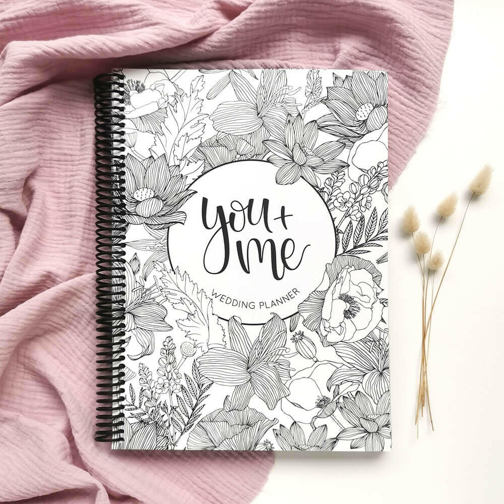 You and Me wedding planner front cover flat lay with dried bunny tails on pink textured background, engagement gift by Paper Heart Design NZ