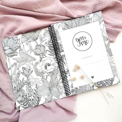 You and Me wedding planner open to title page showing floral inner cover with dried bunny tails on pink textured background, by Paper Heart Design NZ